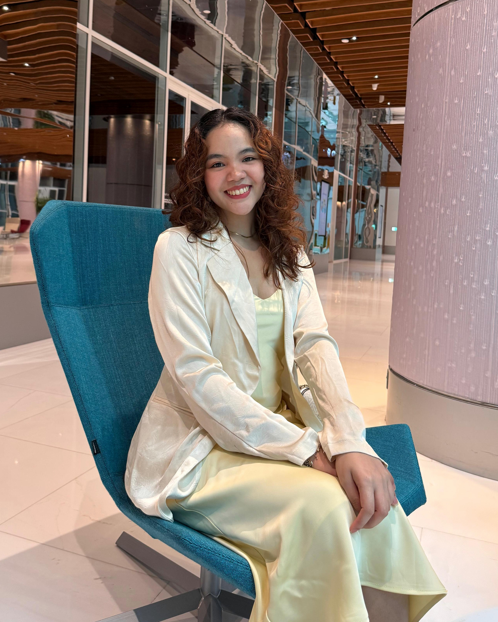 Sydelle Badelles, founder of She Walks With God, seated in a cream blazer